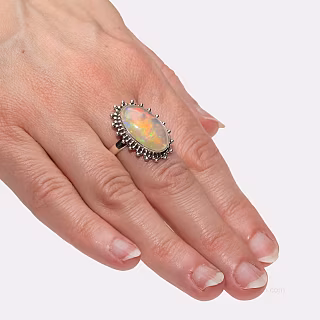 Ring with precious opal - aurora on the finger