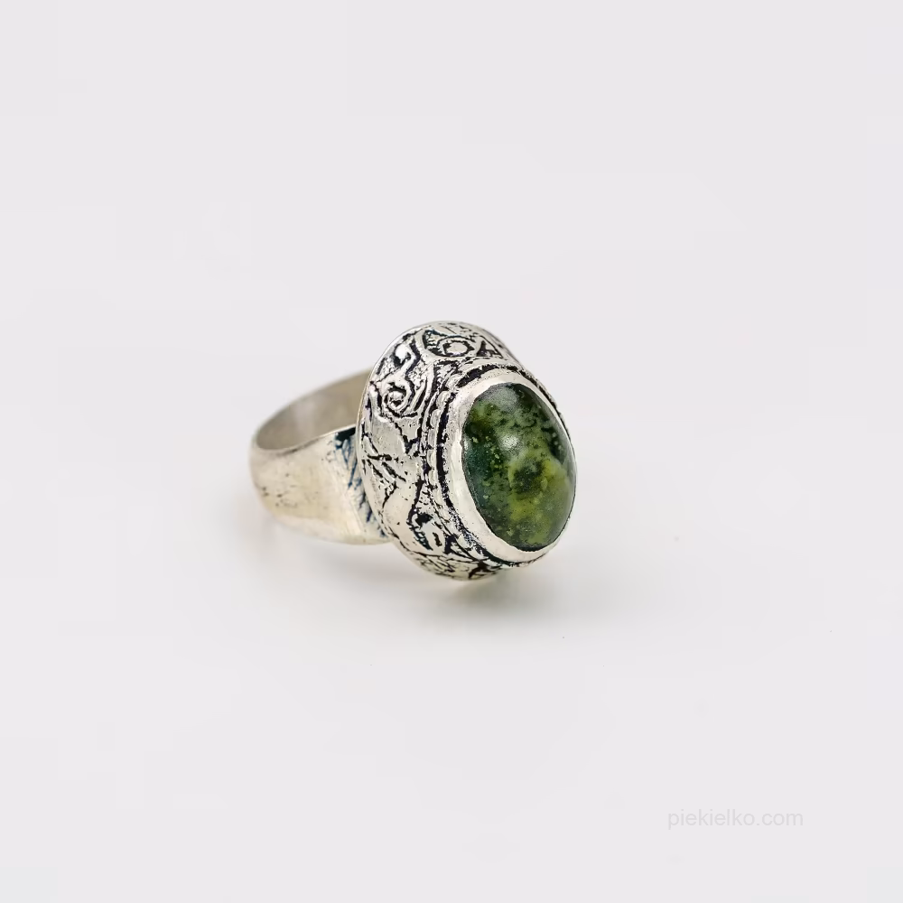 A signet ring with a green mineral in an oriental crown